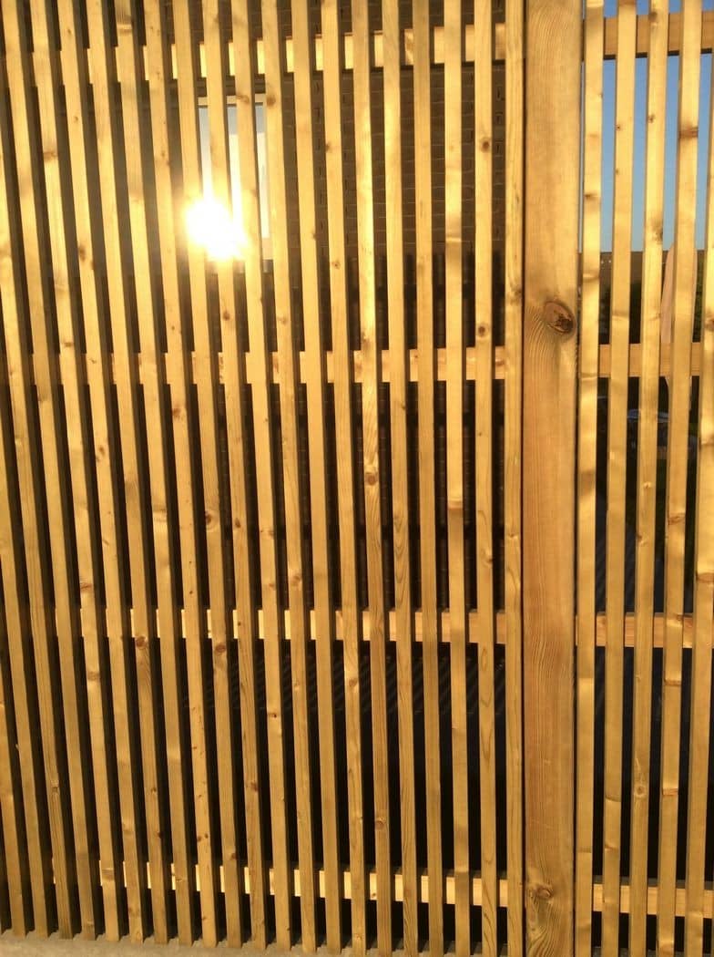 Detail van een verticaal lattenscherm in tegenlicht